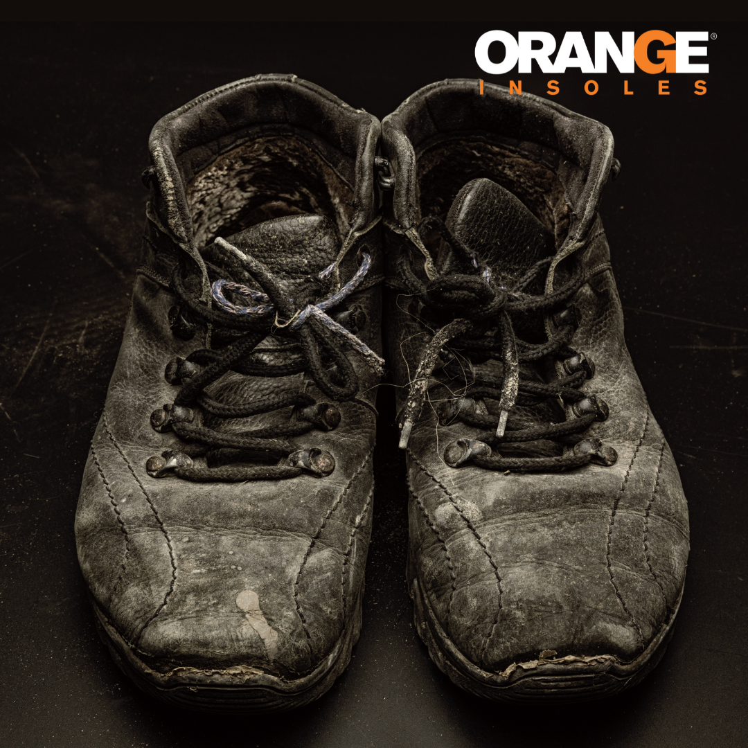 Putting an orange insole in a new (not worn out) shoe.