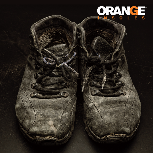 Putting an orange insole in a new (not worn out) shoe.